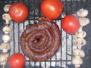 Boerewors cooking over a braai.Pop it on a roll and you're good to go. By AndyRoberts (Flickr)
